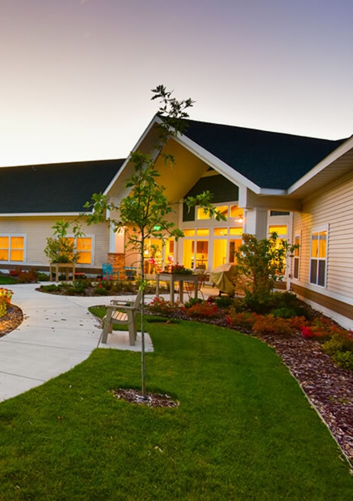 Healthcare facility exterior with landscaped courtyard and walking path
