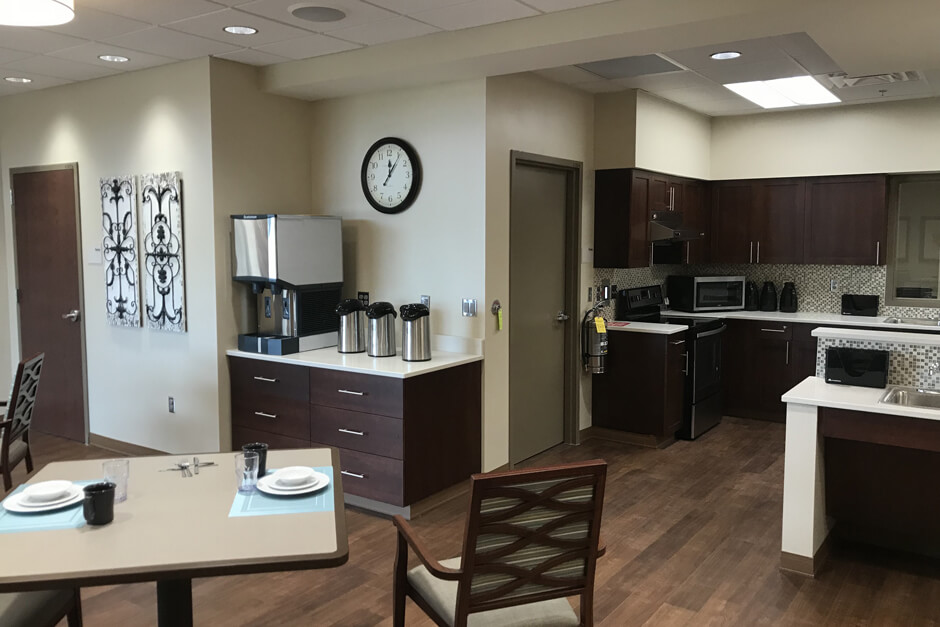 Glencoe Regional Health Services kitchen and dining area with tables and cabinetry