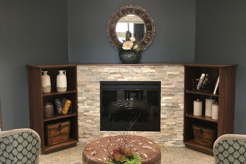 Glencoe Regional Health Services lounge with fireplace and built-in shelving