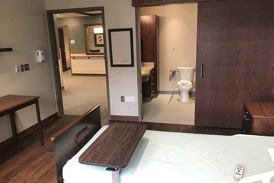 Glencoe Regional Health Services patient room with bed and private bathroom