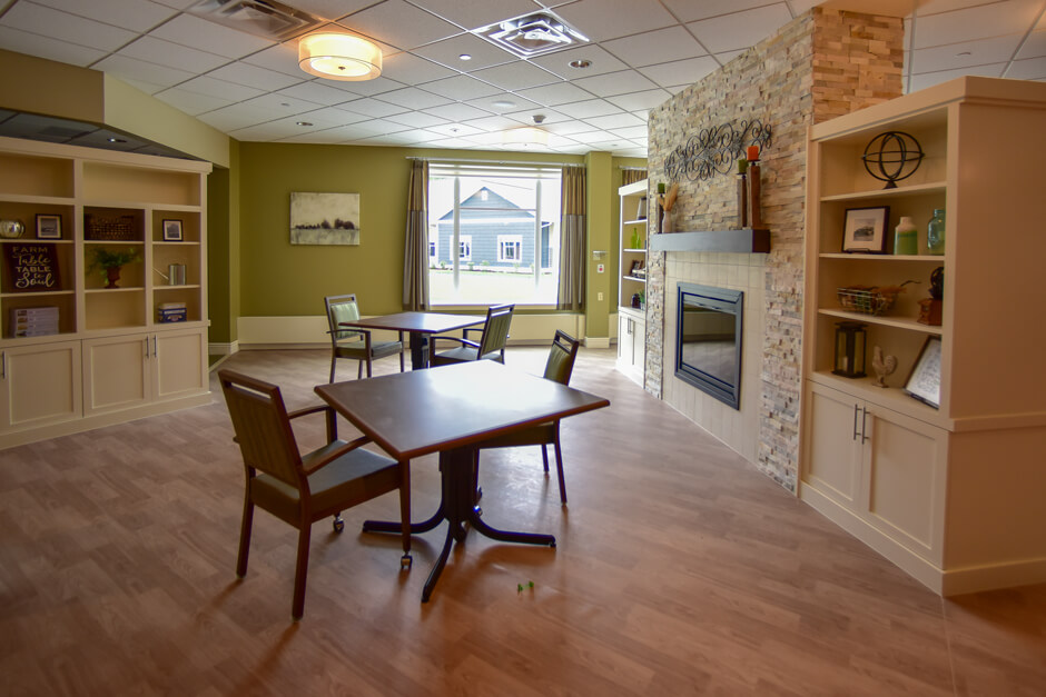 Johnson Memorial Health Services dining room with fireplace and built-in shelving