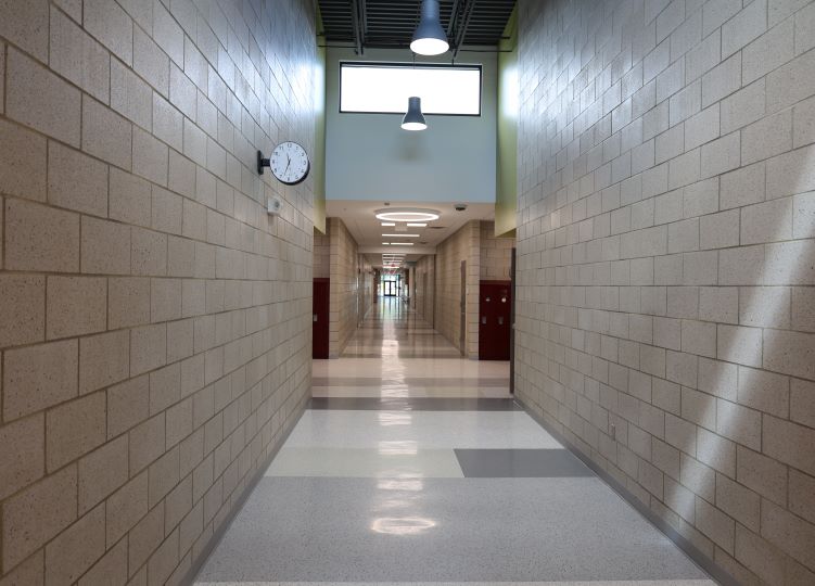 Milbank Elementary hallway with block walls and overhead lighting