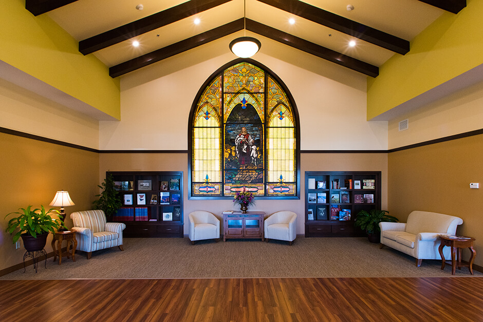 Ortonville Area Health Services sitting area with stained glass window and vaulted ceiling