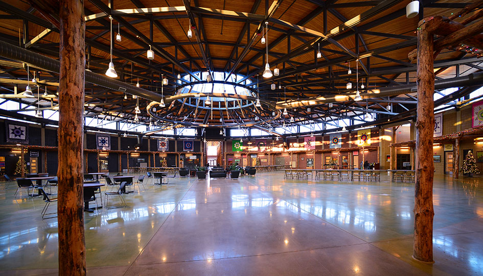 Interior gathering space at the Sisseton Wahpeton Oyate Tribal Administration Building with timber columns and circular skylight