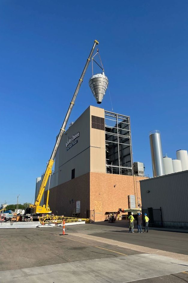 Crane lifting equipment into place at Valley Queen Cheese Factory